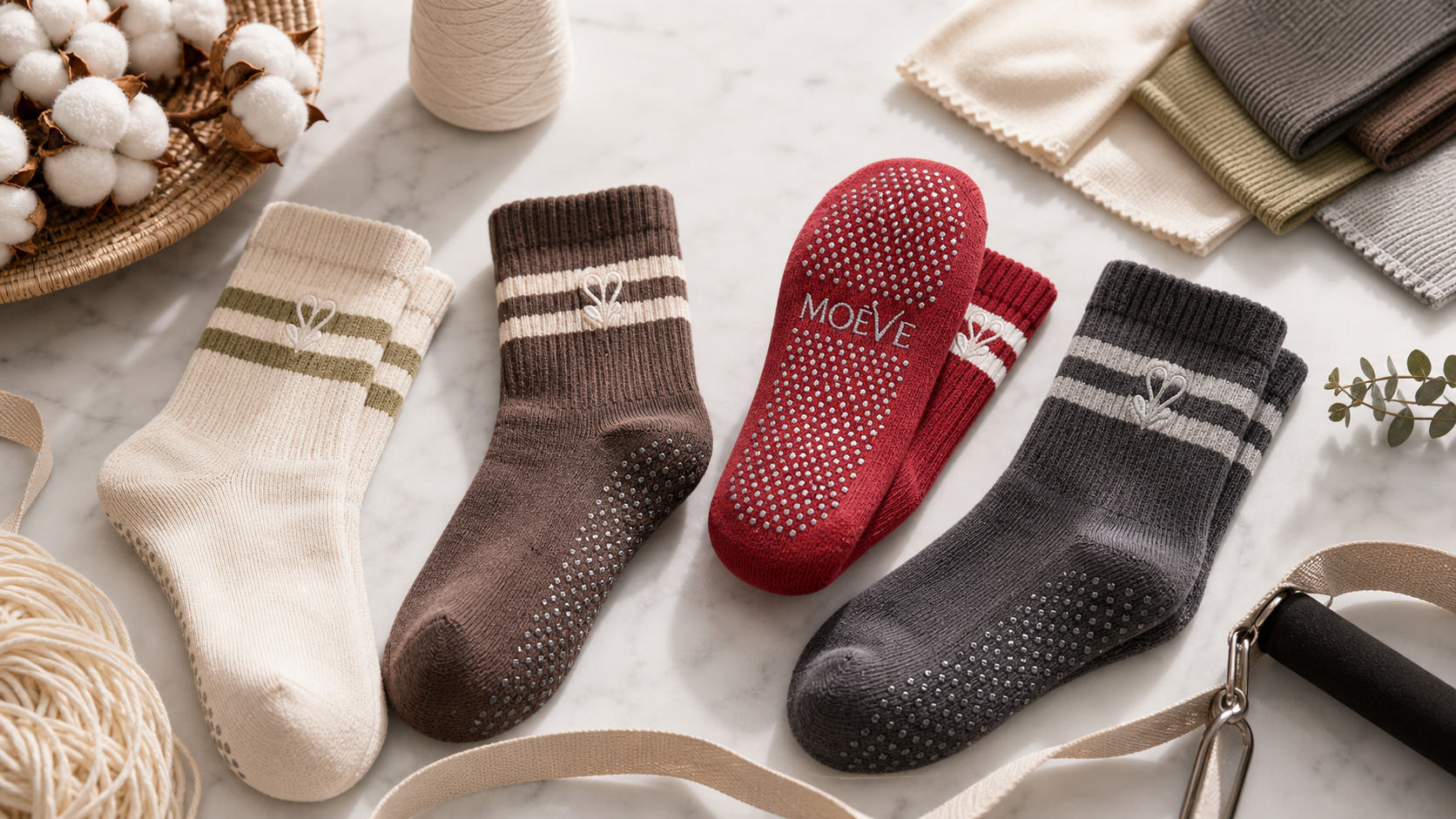 MOÉVE Pilates grip socks styled with premium fabric swatches and material details